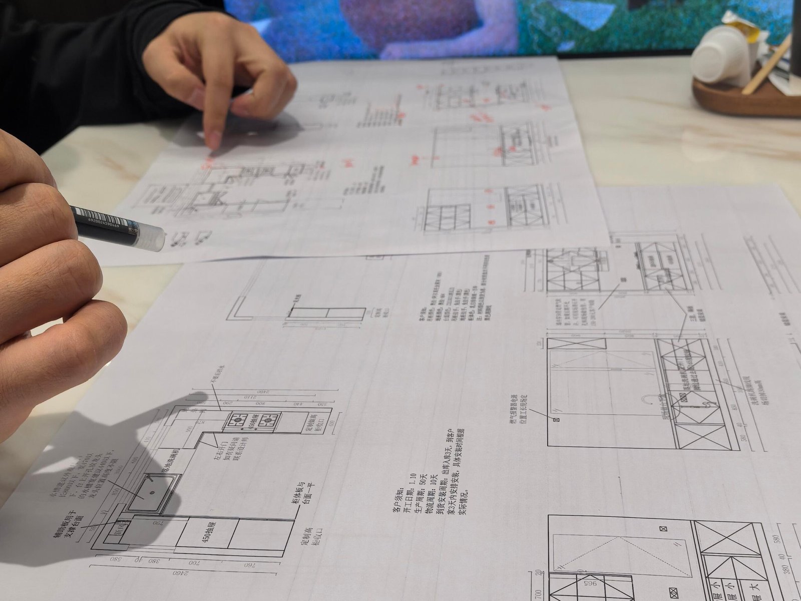 B2B custom cabinet manufacturer reviewing shop drawings with redline updates