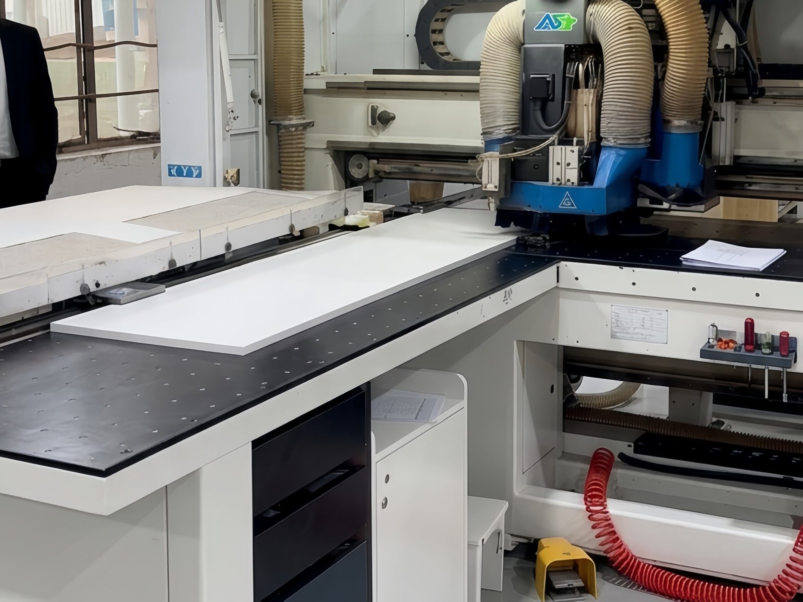 CNC nested routing machine processing custom cabinet panels based on approved shop drawings