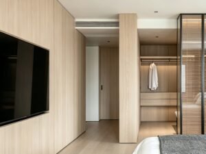 Finished custom built-in wardrobe cabinetry with precise internal partitioning and hardware integration
