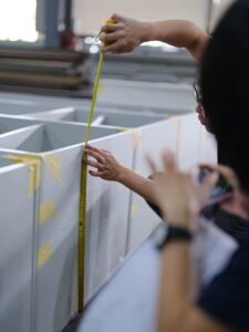 Pre-shipment factory trial assembly of custom cabinet modules by a custom cabinet manufacturer.